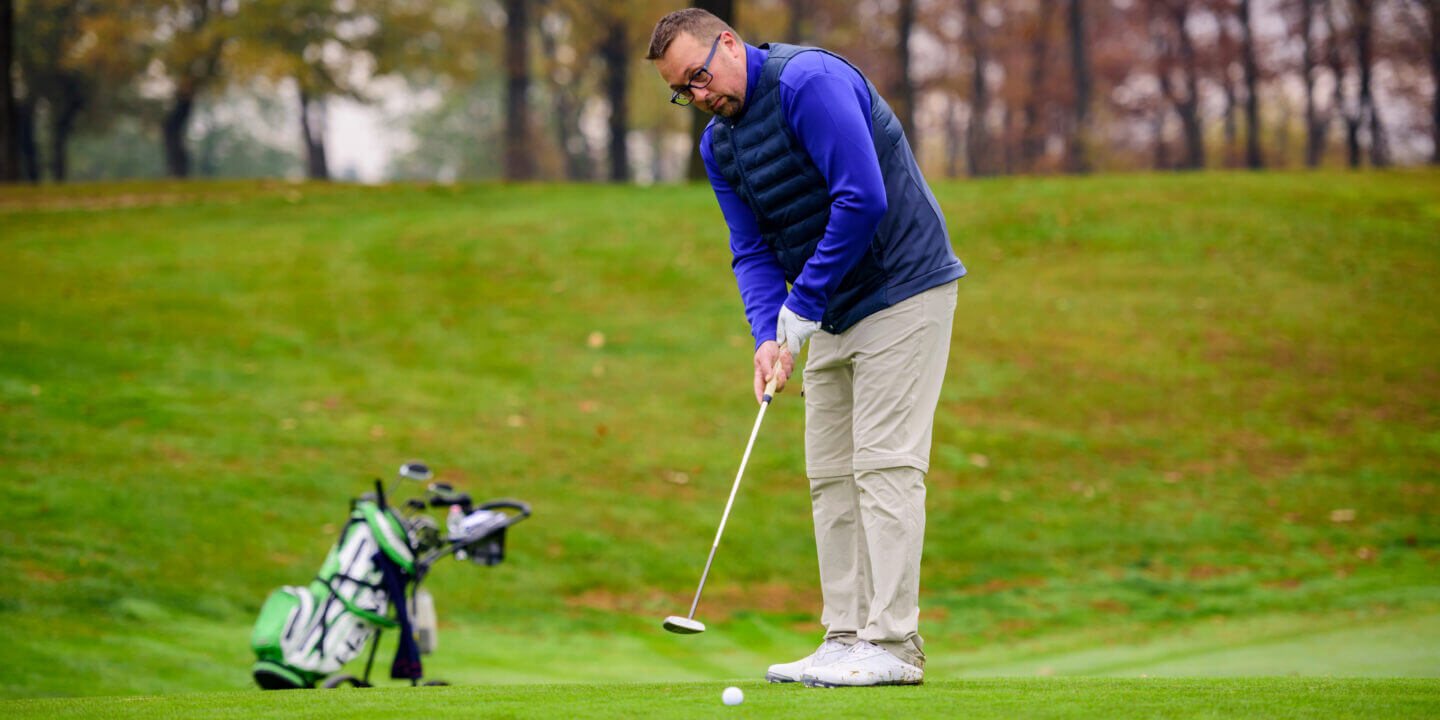 Man playing golf at golf course