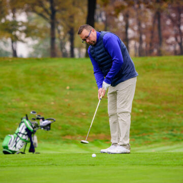 Man playing golf at golf course