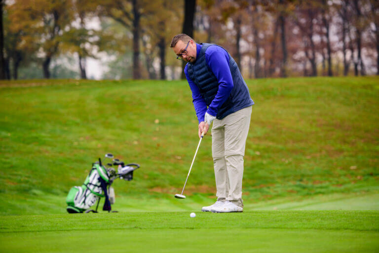 Man playing golf at golf course